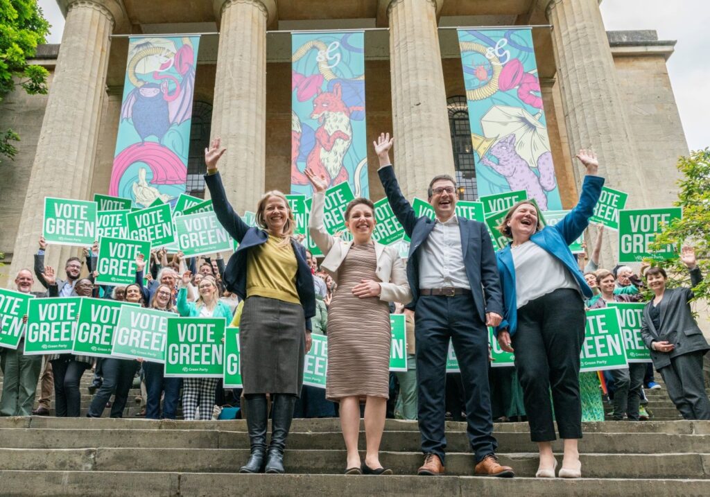The four new Green MPs celebrating with supporters